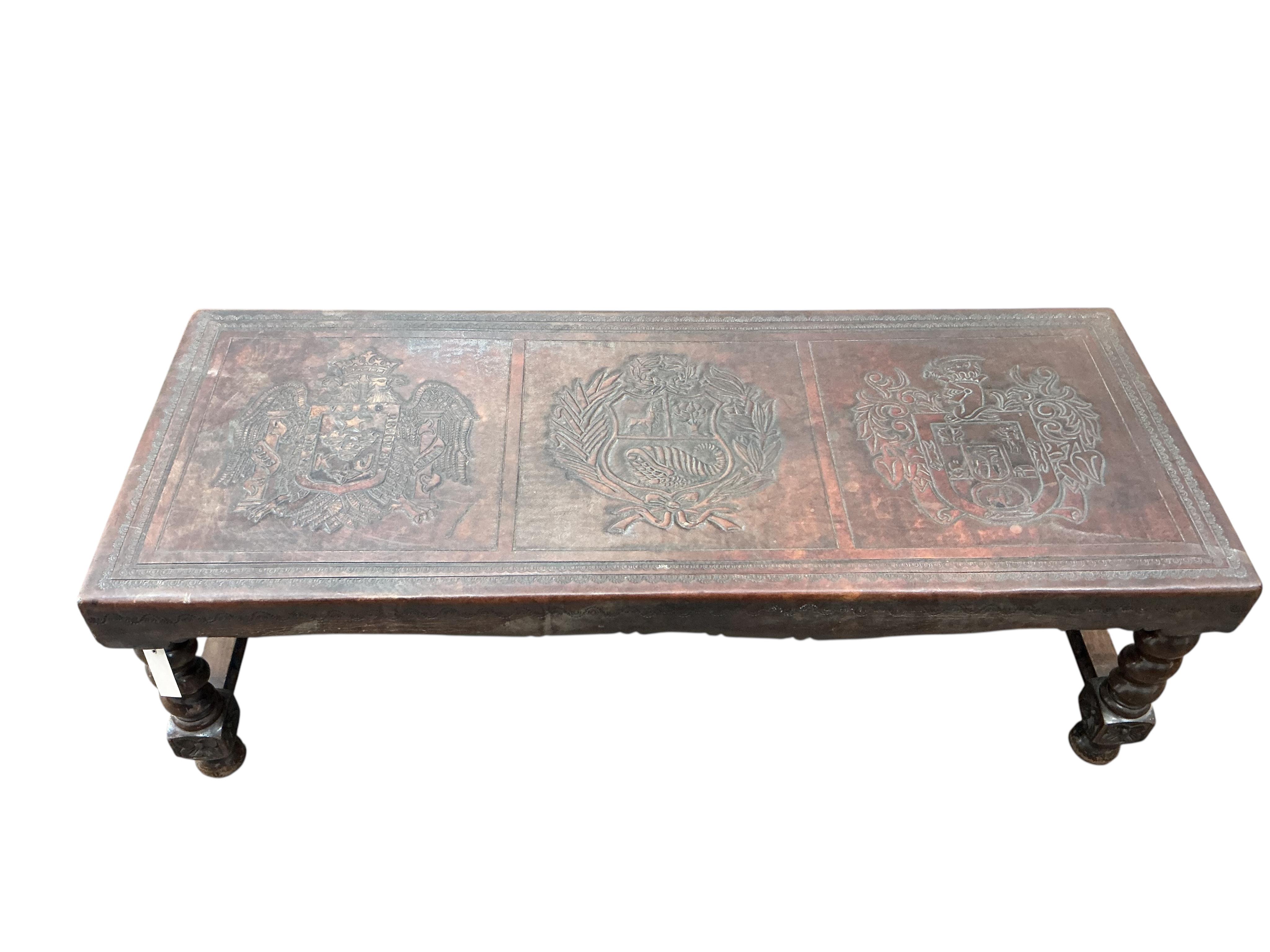 A Peruvian rectangular embossed leather turned wood coffee table, width 128cm, depth 50cm, height 42cm together with a similar nest of tables